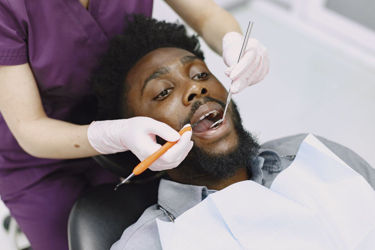 dental check-up cost Vashi, dentist examining a patient's teeth
