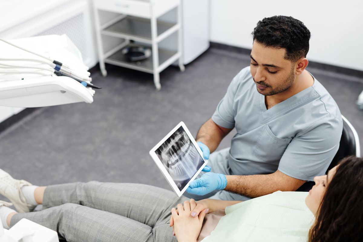 dental crown cost Vashi dentist showing an X-ray to a patient at a Sector 17 Navi Mumbai clinic