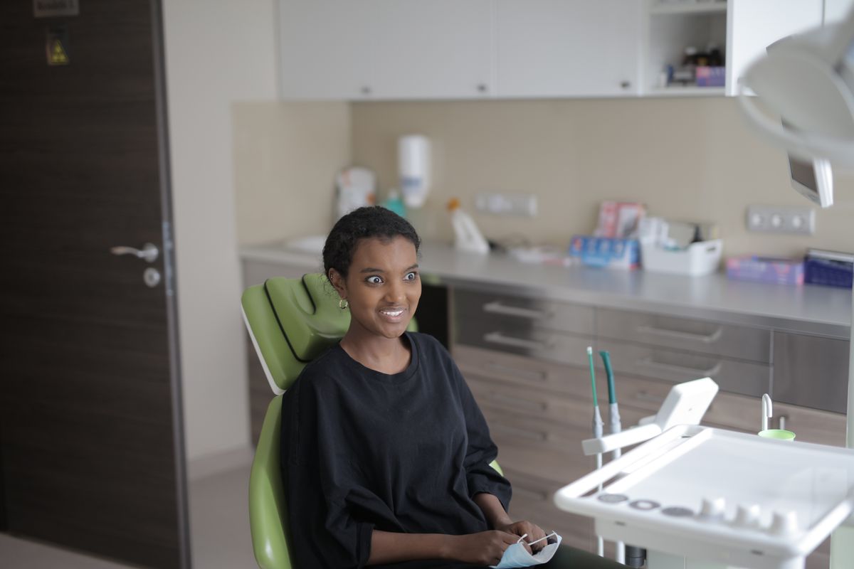 dentist near me vashi smiling patient in a treatment chair at a Sector 17 Navi Mumbai dental clinic