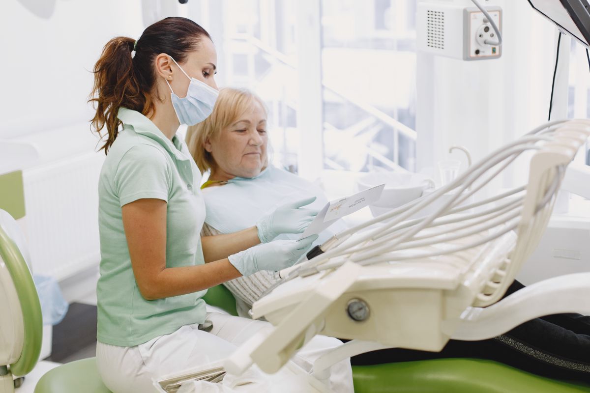 dentures vs bridges vashi consultation between dentist and senior patient at a Sector 17 Navi Mumbai clinic