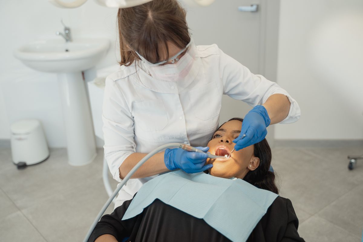 food stuck between teeth Vashi, dentist examining a patient's lower back teeth