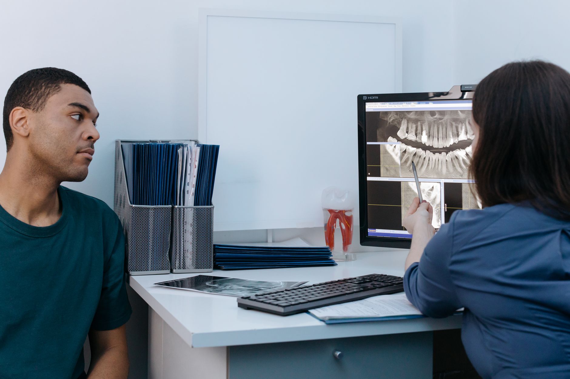 wisdom tooth removal vashi navi mumbai dentist reviewing dental x-ray with patient at clinic